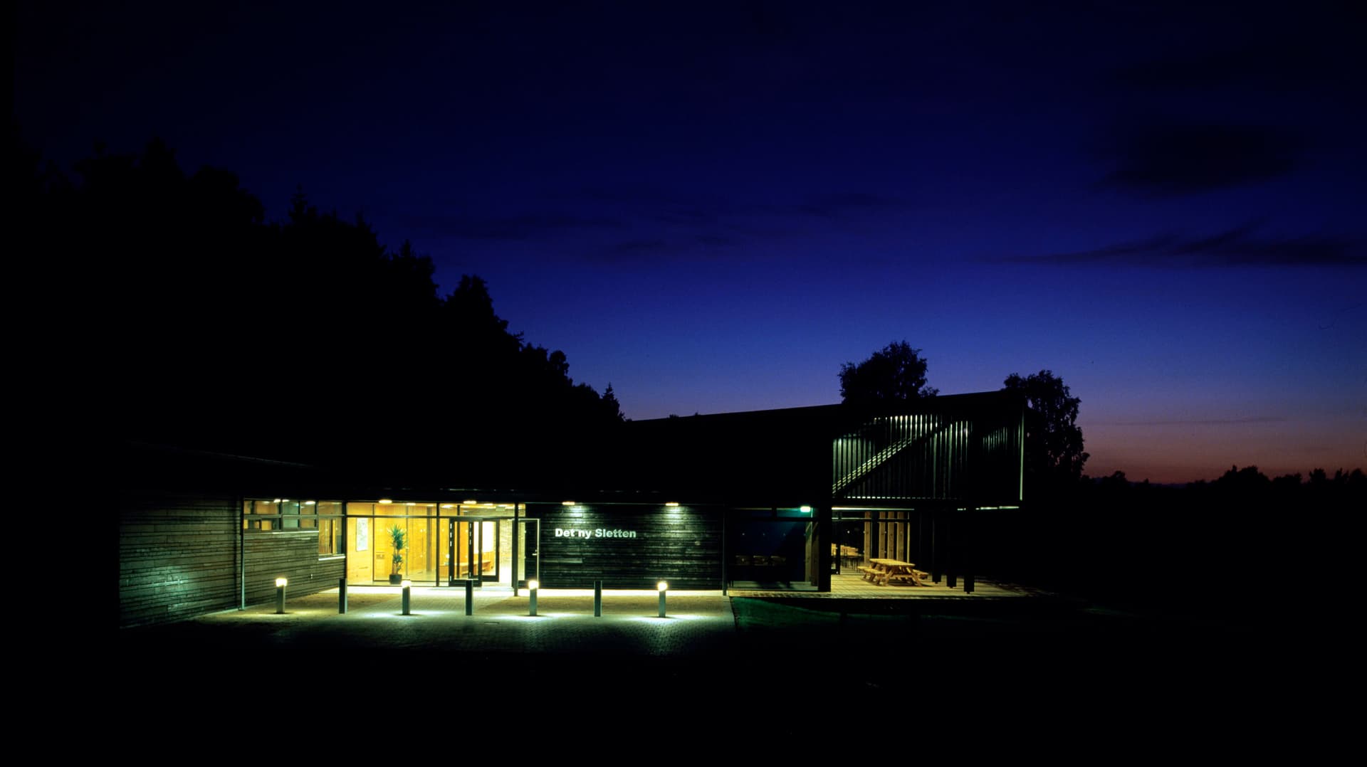The outdoor centre glows up the night sky.