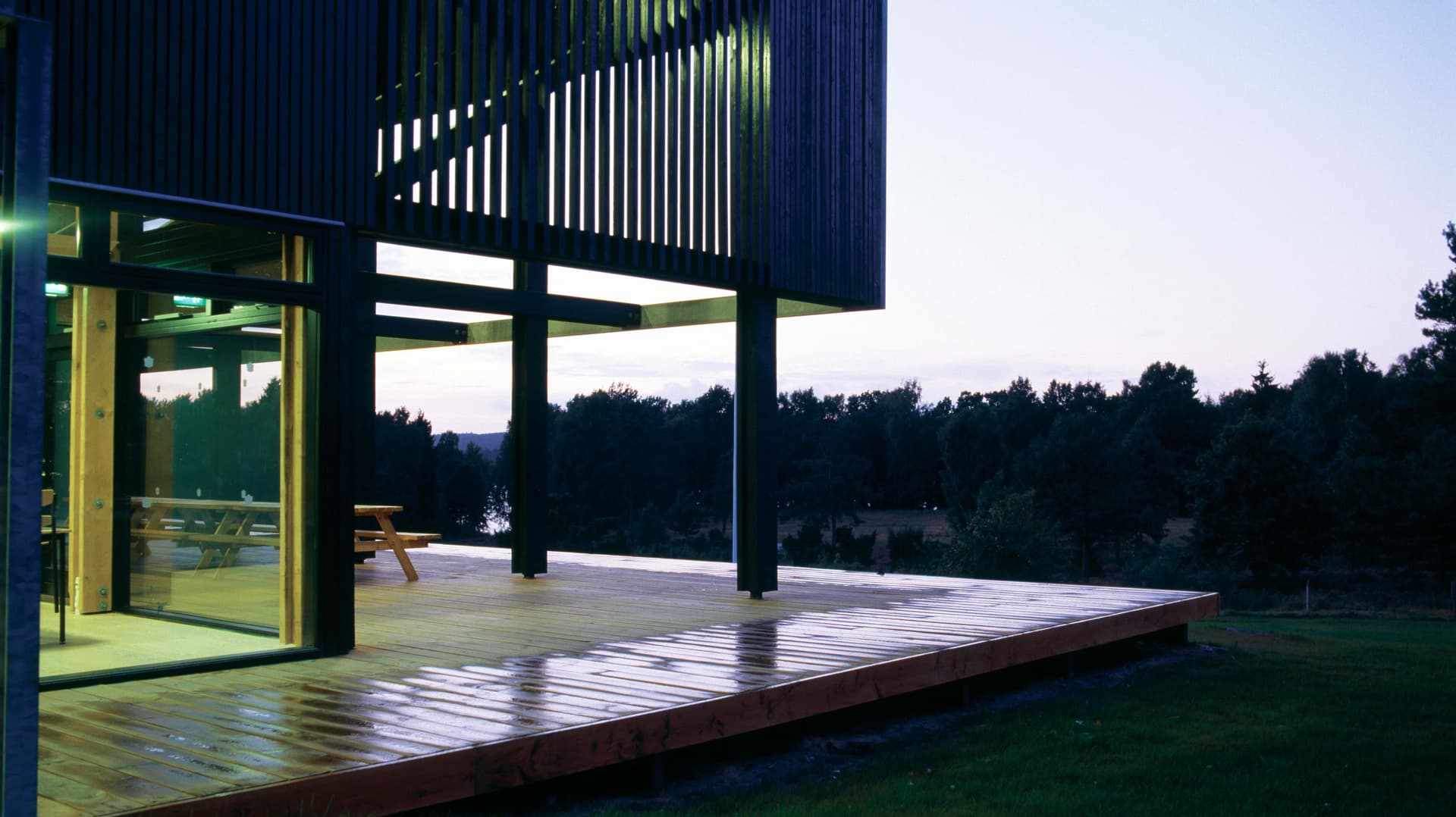 The wooden transparent front of the building offers a panoramic view of the highland lake area.